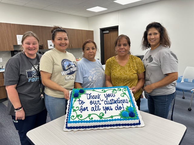 WPHS custodial staff members receive a cake from fellow WPHS faculty in honor of Custodian Appreciation Day.