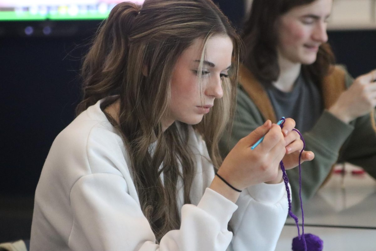 Eleri Gomez (9) concentrating on her project in Courtney Plottss session, Hooked on Yarn. 